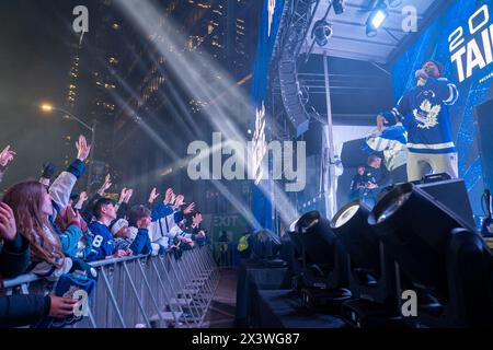 April 24, 2024, Toronto, Ontario, Canada: Fans in front of the Tailgate stage at Maple Leaf Square outside Scotibank Arena, during Round 1, Game 4 playoff game of Toronto Maple Leafs vs Boston Bruins playoff game on a giant screen. During Toronto Maple Leafs playoff games, Maple Leaf Square transforms into a sea of blue and white, echoing with the chants of passionate fans eagerly rallying behind their team's quest for victory. The electric atmosphere radiates anticipation and excitement, creating unforgettable memories for both die-hard supporters and casual observers alike. (Credit Image: © Stock Photo