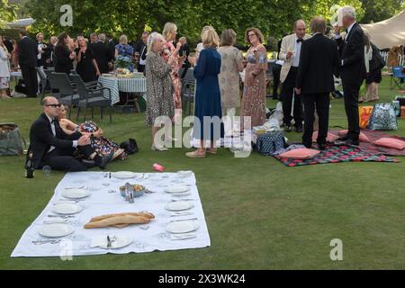 Waiting for guests to arrive 2020s UK. They are late, everyone else has started on their summer garden party alfresco picnic. The Hurlingham Club which is an exclusive private social club in the Fulham area of London. The annual summer garden party - Fête Champête, London, England 11th June 2022 UK 2020s HOMER SYKES Stock Photo