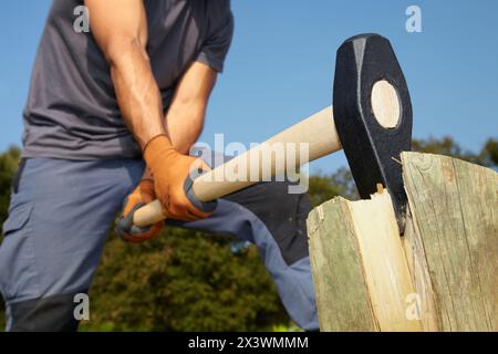 Farmer cutting wood with wedge club, Sledgehammer wedge, Agricultural and gardening hand tool, Usurbil, Gipuzkoa, Basque Country, Spain Stock Photo