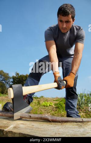 Farmer chopping wood with an ax, Axe, Agricultural and gardening hand tool, Usurbil, Gipuzkoa, Basque Country, Spain Stock Photo
