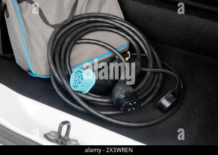 France. Seine et Marne. Electric car Renault Zoe. Close up on charging cable (type 2 and type 3) in the car trunk. Stock Photo