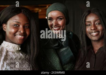 Halima Aden (C) seen taking pictures with girls of African origins ...