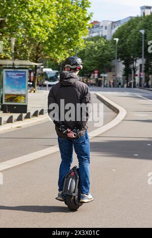 France, Nantes, 44, Cours des 50 Otages, man moving on an electric mono-wheel, also called e-wheel or gyroscopic wheel, May 2021. Stock Photo