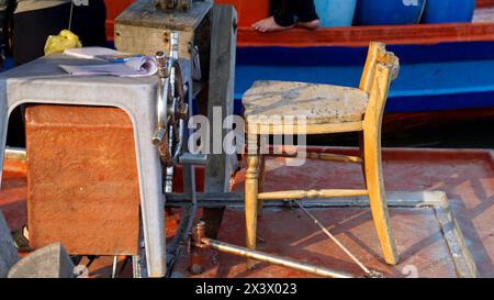 rotten wooden chair as captains seat on a boat Stock Photo