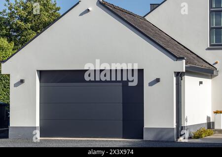 White garage extension with surveillance camera under the gable Stock Photo