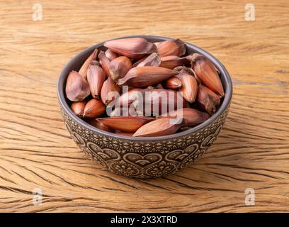 Pinions or pine tree seeds on a bowl over wooden table. Stock Photo