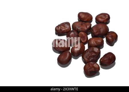 Dry seeds of pepper beans, ready for planting in the vegetable garden, on a white background. Close-up. Stock Photo