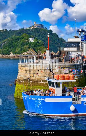 Tourist boat that makes the excursion from the Port of Donostiarra to Santa Clara Island, where the Casa del Faro is located with the work HondaleaÂ b Stock Photo