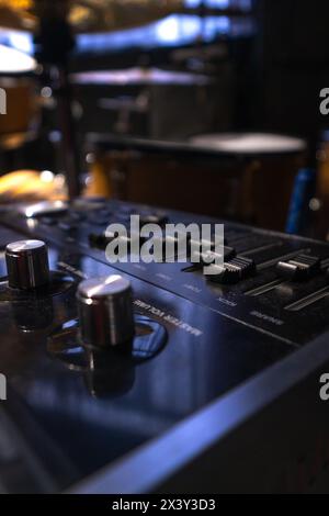 Close-up of a professional music mixer in the studio, selective focus. Vertical photo Stock Photo