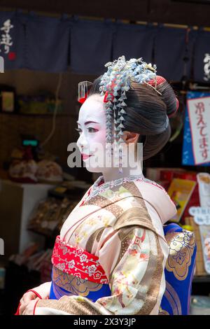 Kyoto, Japan - 15 June 2016: Woman in Geisha costume and makeup on the ancient streets of Kyoto. Famous as an area for Geishas. Stock Photo