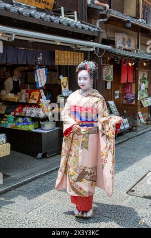 Kyoto, Japan - 15 June 2016: Woman in Geisha costume and makeup on the ancient streets of Kyoto. Famous as an area for Geishas. Stock Photo