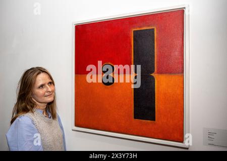 London, UK.  29 April 2024. Artist Emma Alcock with her work 'Reflection', 2016, at the preview of artworks for ‘AT The Bus’, an exhibition of works donated by leading artists to support charity, offering art as therapy for young people.  The exhibition is open to the public from 29 April to 7 May in Sotheby’s New Bond Street galleries after which the artworks will be offered for sale in an online auction powered by Artsy.  Credit: Stephen Chung / Alamy Live News Stock Photo