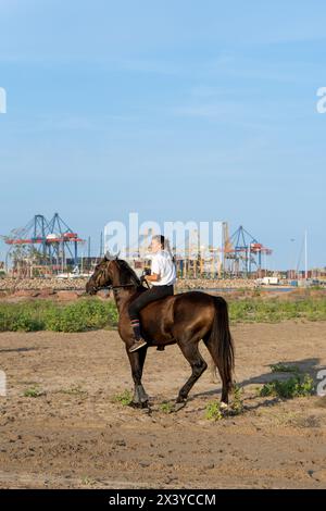 Pinedo (Valencia), Spain - September 17, 2022: A horsewoman riding bareback on the beach of Pinedo, Valencia, before a traditional race with the port Stock Photo