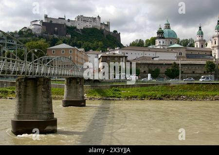 Mozartsteg bridge over The River Salzach. Featured in The Sound of Music movie. Saltzburg Castle behind. Stock Photo