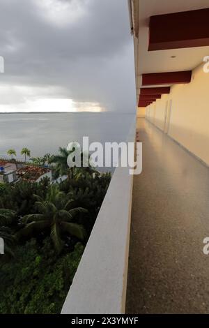 204 The open hallway leading to the rooms in the Jagua Hotel, views to the stormy sky over Jagua Bay after heavy tropical downpour. Cienfuegos-Cuba. Stock Photo