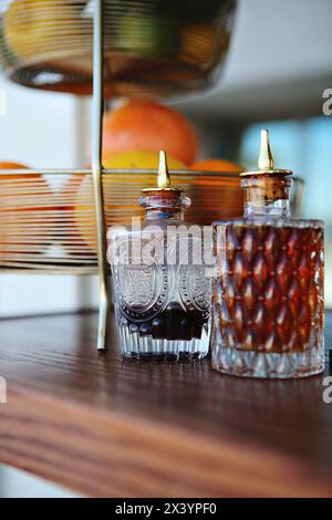 Vintage bitters bottles with intricate designs on a bar setup. Stock Photo