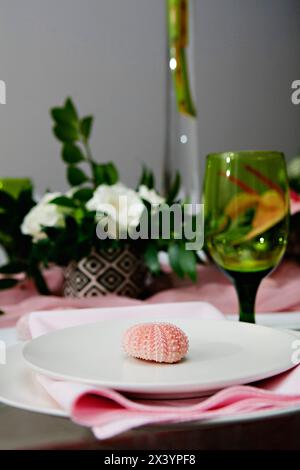 Delicate table decor with pink touches and seashell detail Stock Photo