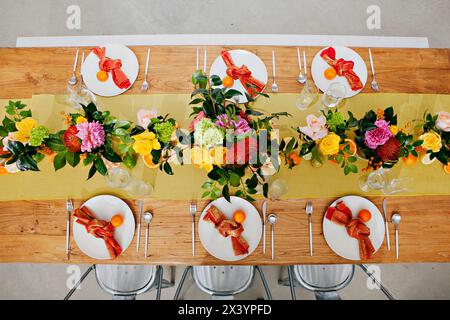 Lively table setting with floral and citrus elements. Stock Photo