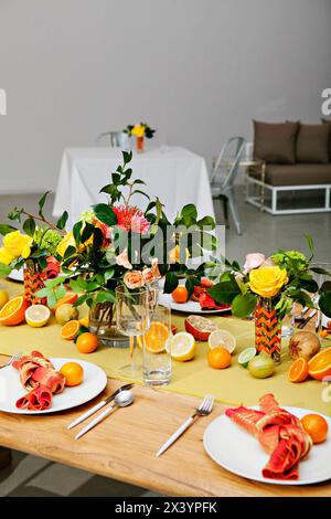 Colorful dining table with a fresh citrus and floral theme. Stock Photo