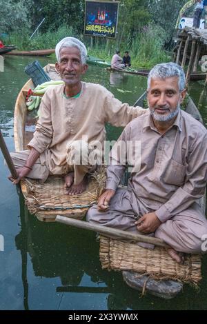 Floating market vendors enjoying a smoke, Dal Lake, Srinagar, Kashmir, India Stock Photo