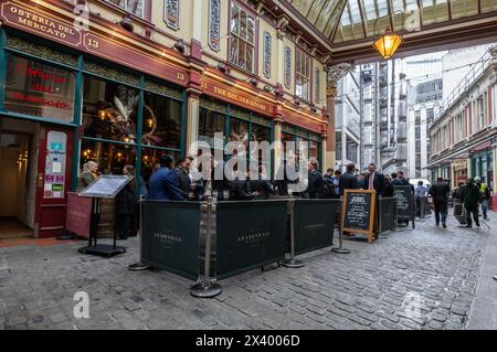 Businessmen and city workers have a lunchtime drink at the Golden Goose at Leadenhall Market, City of London, England, United Kingdom Stock Photo
