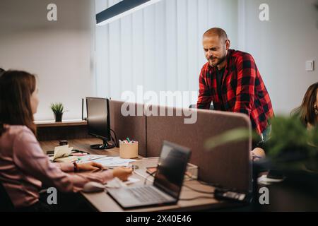 Business teamwork in a modern office: Workers engaging in a collaborative project Stock Photo