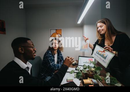 Multicultural team analyzing and discussing sales growth statistics in office Stock Photo