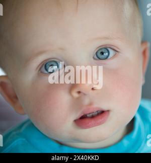 Close-up portrait of a baby boy with big blue eyes; San Diego, California, United States of America Stock Photo