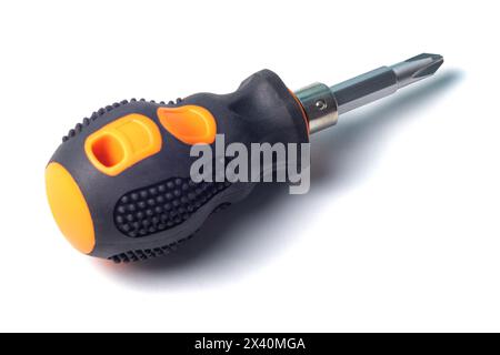 Phillips screwdriver with short orange and black rubberized handle isolated on a white background, close-up macro view Stock Photo