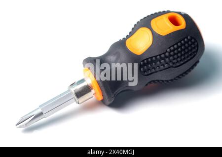 Phillips screwdriver with short orange and black rubberized handle isolated on a white background, close-up macro view Stock Photo