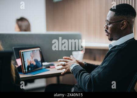 Focused businessman during a teamwork session, interacting in a modern office setting Stock Photo