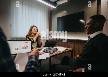 Multicultural team analyzing growth statistics in modern office setting Stock Photo