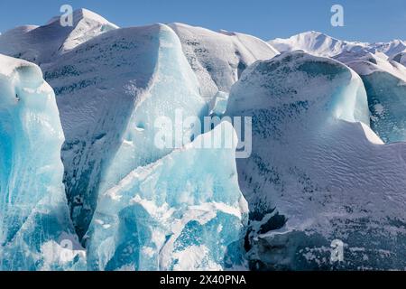 Blue ice formations on Knik glacier against a bright blue sky; Alaska, United States of America Stock Photo