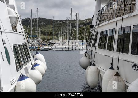 White fenders hang from boats in the port of Santa Teresa, a town on the northern tip of Sardinia, on the Strait of Bonifacio, in the province of S... Stock Photo