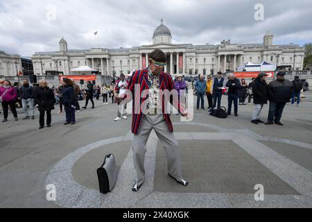 Man dressed in 1960's attire attends The Feast of St. George Festival in Trafalgar Square, April 23rd 2024 Stock Photo