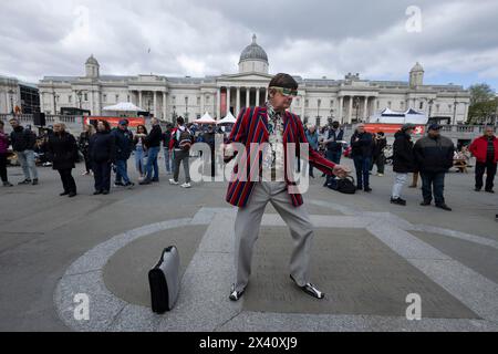 Man dressed in 1960's attire attends The Feast of St. George Festival in Trafalgar Square, April 23rd 2024 Stock Photo