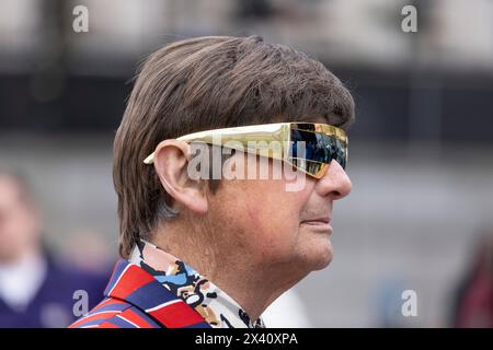 Man dressed in 1960's attire attends The Feast of St. George Festival in Trafalgar Square, April 23rd 2024 Stock Photo