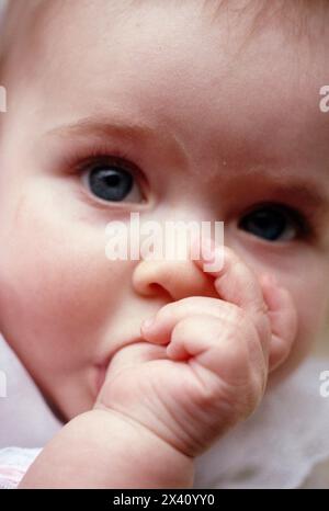 Close view of a baby sucking her thumb; Mystic, Connecticut, United States of America Stock Photo