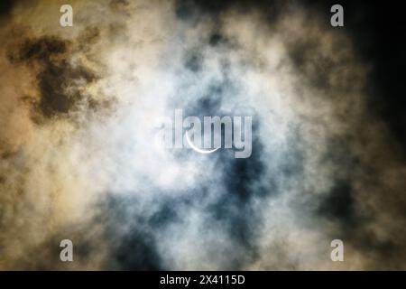Solar eclipse on April 8, 2024 as seen with partial cloud cover in Central Kentucky Stock Photo