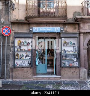 Storefront with wares on display in front windows in Bosa, Italy; Bosa, Oristano, Italy Stock Photo