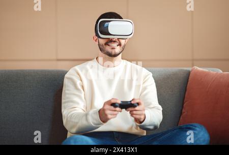 Young Man Engages in Virtual Reality Gaming at Home Stock Photo