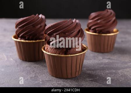 Delicious chocolate cupcakes on grey table, closeup Stock Photo