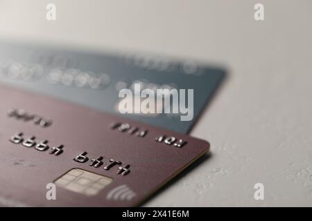 Two credit cards on gray background, closeup Stock Photo