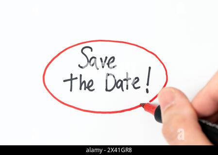 Hand writing text save the date with red marker pen Stock Photo
