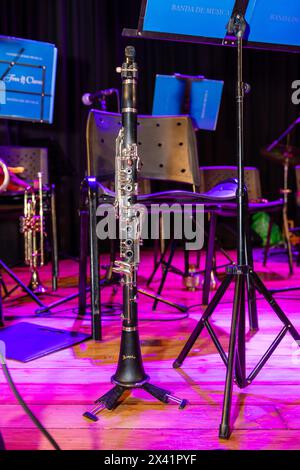A black and white clarinet is on a stand in front of a blue sign. The sign says "Blues for Drums." Stock Photo