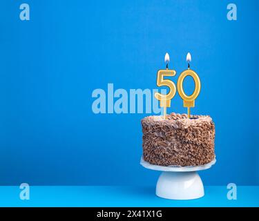 Birthday cake with candle 50 - Invitation card on blue background Stock Photo