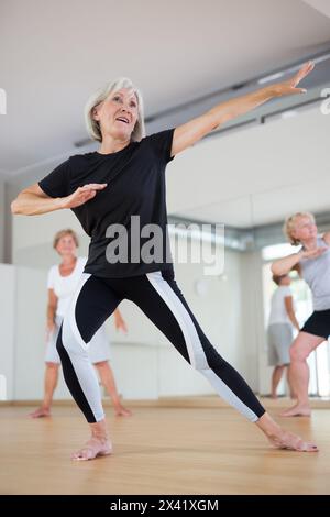 Mature dancing woman practices energetic swing Stock Photo - Alamy