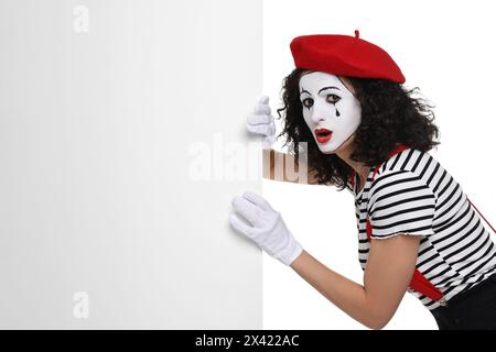 Funny mime with blank poster posing on white background Stock Photo