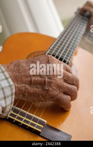 classical guitar, hands of a person playing musical instruments with strings, classical music, object wallpaper Stock Photo
