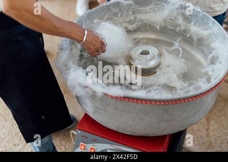 Cotton candy, candy floss and fairy floss surved at social event to kids. its made from sugar at machine. Stock Photo